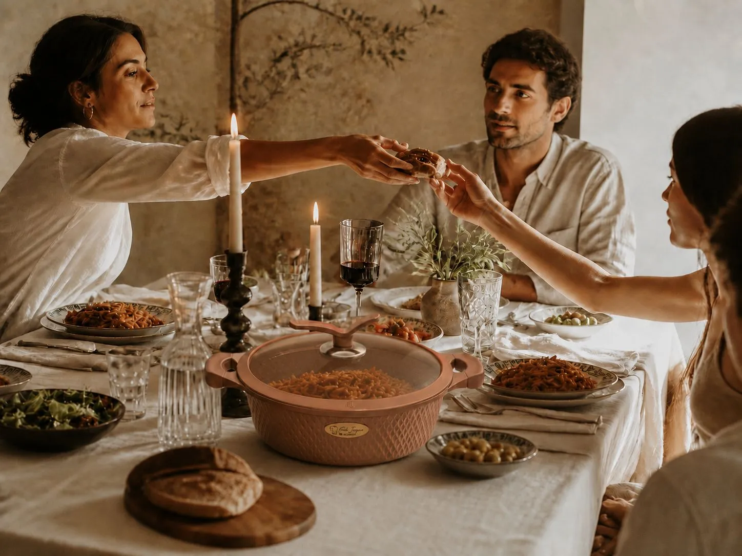 Family gathered at the table with a MONCOC pot sharing a meal
